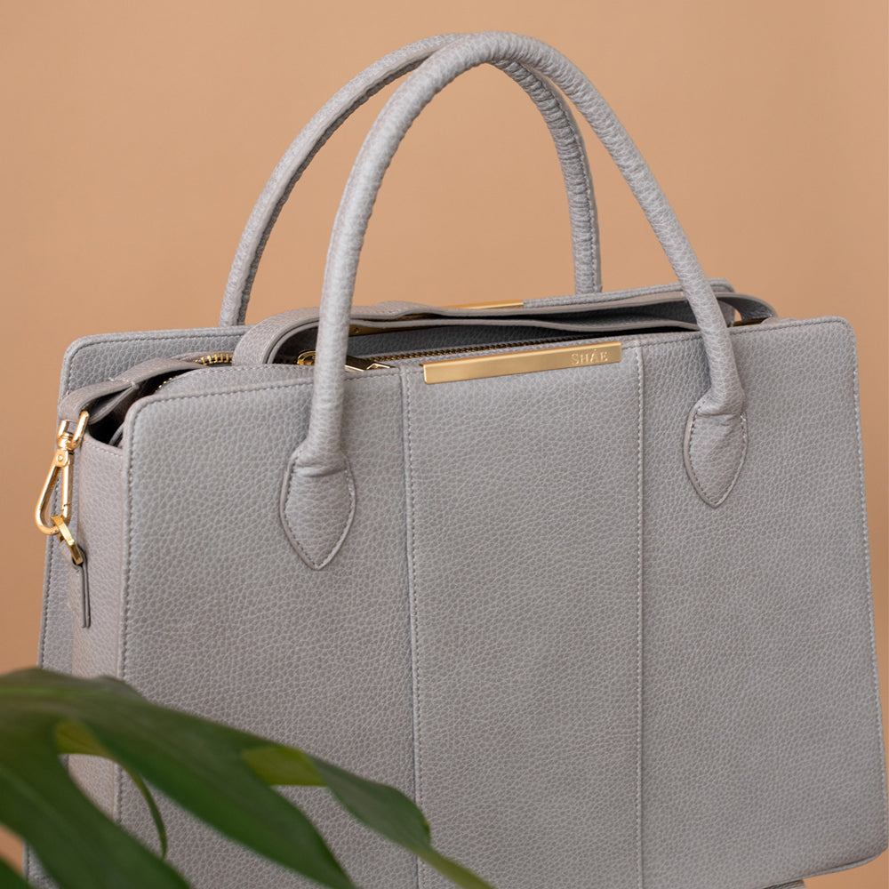 Grey work bag with gold accents